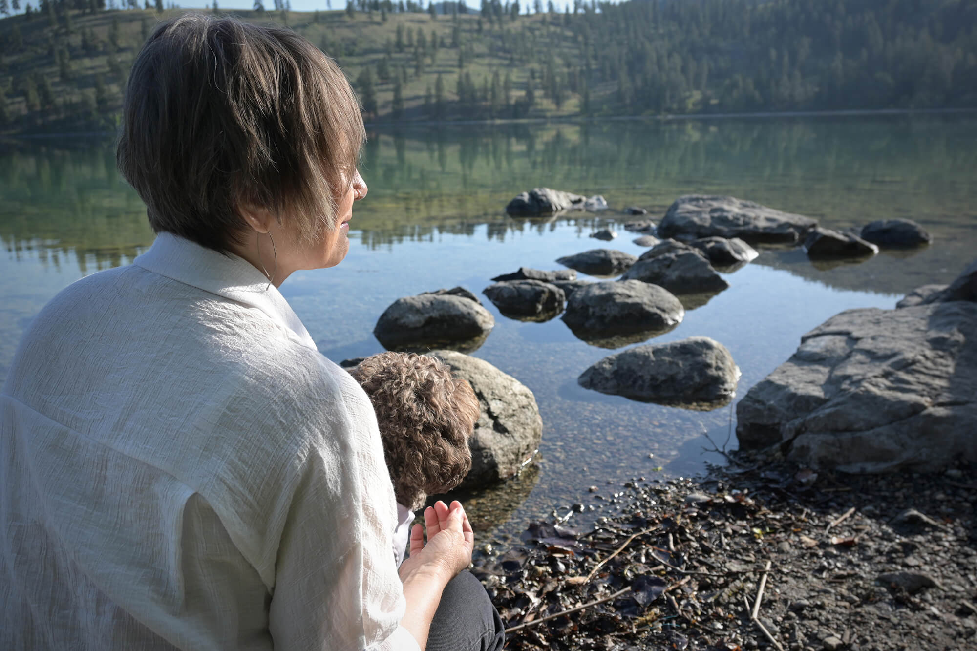 katia-lake Lois of Hansen Counselling looking out into the water in Lake Country, BC